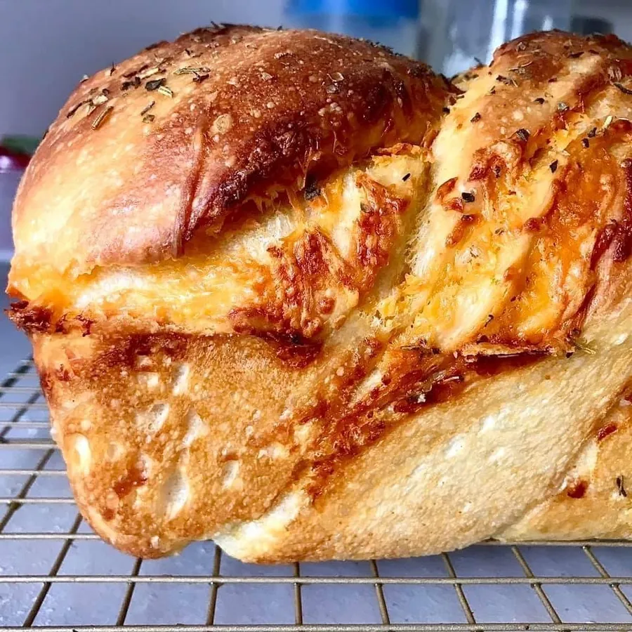 A sourdough loaf cut open to show an open, irregular crumb