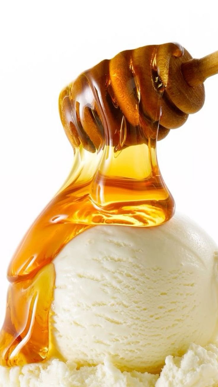 Golden honey drizzling from a dipper over a scoop of vanilla ice cream, the dessert, fine-dining photography for YQR Design