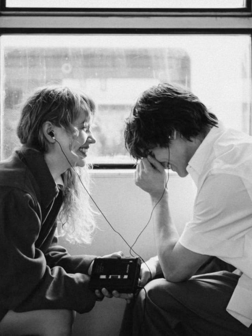 MutualClause fine-jewelry campaign by YQR Design, a tender black-and-white moment between a couple sharing music